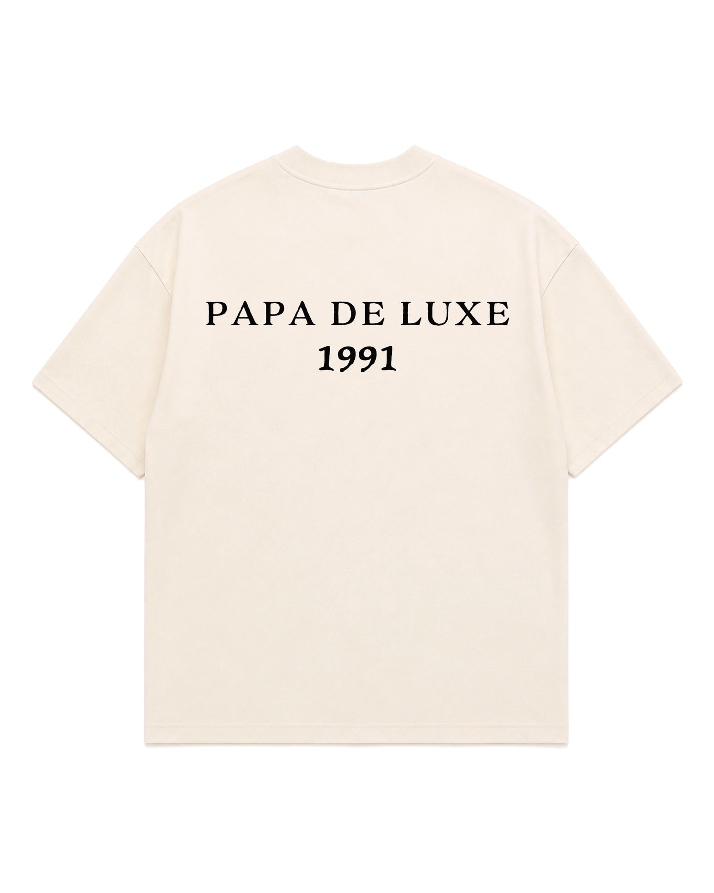 An off-white short-sleeve t-shirt with 'PAPA DE LUXE 1991' printed in black serif text across the chest, displayed on a solid white background.