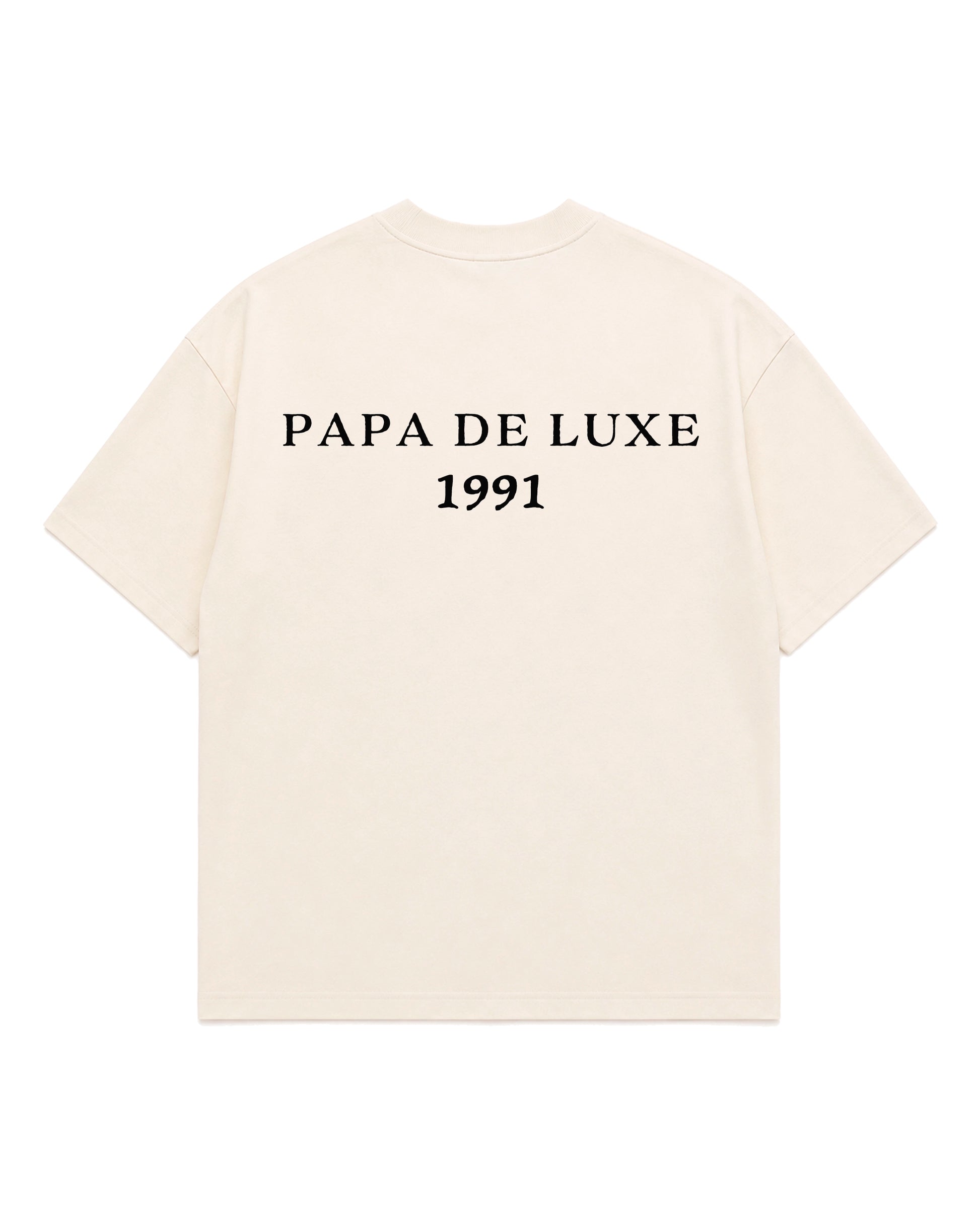An off-white short-sleeve t-shirt with 'PAPA DE LUXE 1991' printed in black serif text across the chest, displayed on a solid white background.