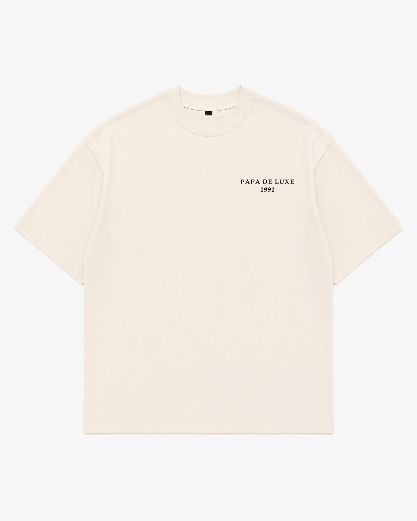 An off-white short-sleeve crewneck t-shirt with 'PAPA DE LUXE 1991' printed in black on the left chest, displayed flat against a light gray background.