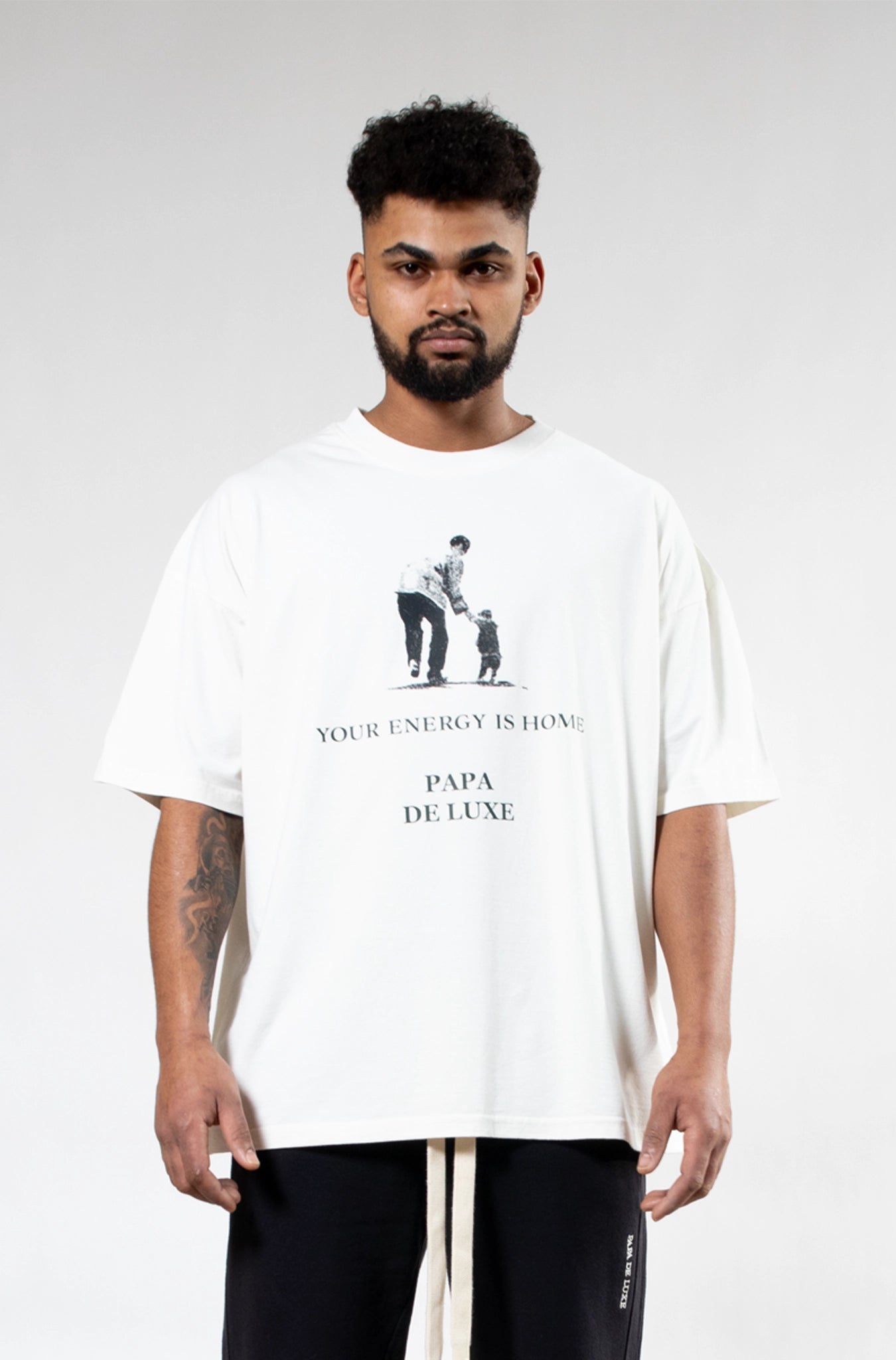 Close-up of Papa De Luxe 'Your Energy Is Home' T-shirt father and child graphic print detail on white cotton