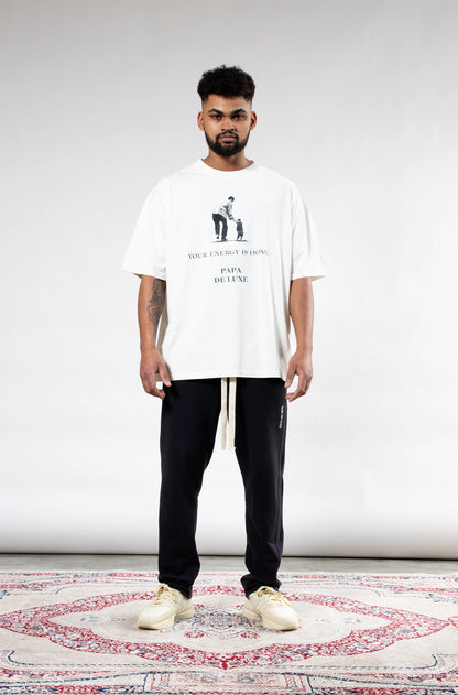 Man wearing Papa De Luxe 'Your Energy Is Home' white graphic T-shirt front view, relaxed oversized fit